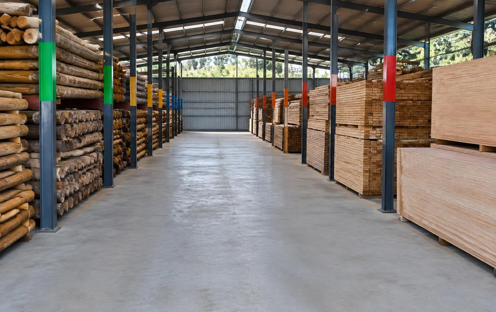 Covered timber warehouse with sorted stock bays marked by colour