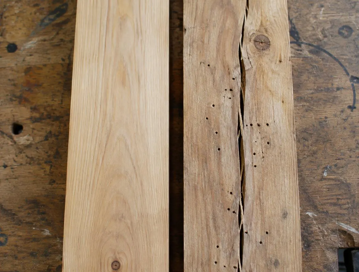 A clean plank beside a rejected plank with a crack and borer holes